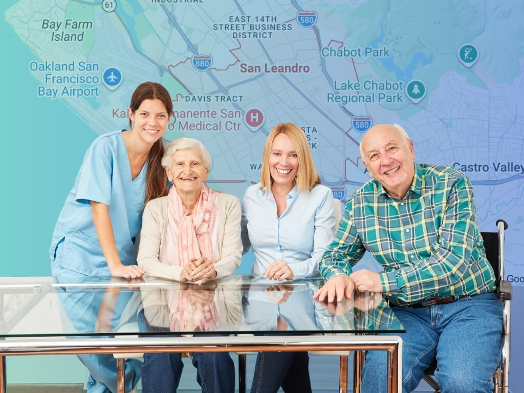 Caregiver, two seniors, and a family member smiling together over a San Leandro, CA map, showing home care in San Leandro