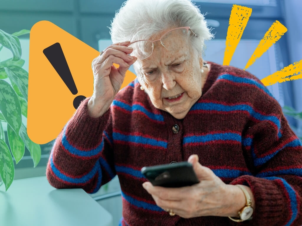 Senior scam awareness: older woman lifting her glasses to study a suspicious message on her phone beside a warning sign